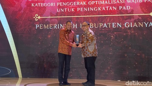 Bupati Gianyar, I Made Mahayastra, saat menerima detikBali Awards 2025 kategori Penggerak Optimalisasi Wajib Pajak untuk Peningkatan PAD di Trans Resort Bali, Sabtu (22/3/2025). (Foto: Daniel Pekuwali/detikBali)