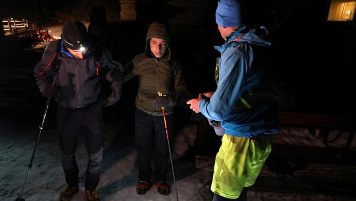 Aksi Pelari Tunanetra Mendaki Gunung Setinggi Everest di Bulgaria Victor Asenov, a visually impaired ultramarathon runner, is guided by pacers Pavlin Beev and Veradina Nacheva as he attempts to cover the same elevation as Mount Everest, an activity known as 'Everesting', by running up and down the Black Peak summit of the Vitosha mountain, to raise awareness of a guide dog school, near Sofia, Bulgaria, March 21, 2025. REUTERS/Spasiyana Sergieva