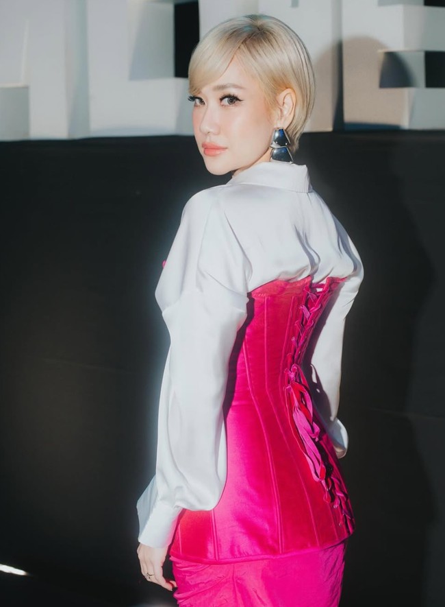 Istri Tiko Aryawardhana itu memadukan kemeja putih dengan set dress berwarna fuschia. Dress dengan model korset itu kemudian dipadukan dengan sepasang sepatu boots berwarna putih. Foto: Instagram/@itsmebcl