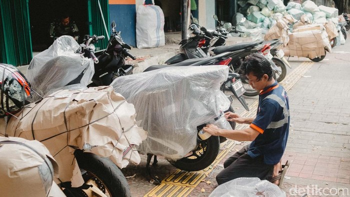 Petugas mempersiapkan motor untuk dikirim menggunakan kereta api di salah satu jasa pengiriman logistik di kawasan Pasar Senen, Jakarta, Selasa (25/3/2025).