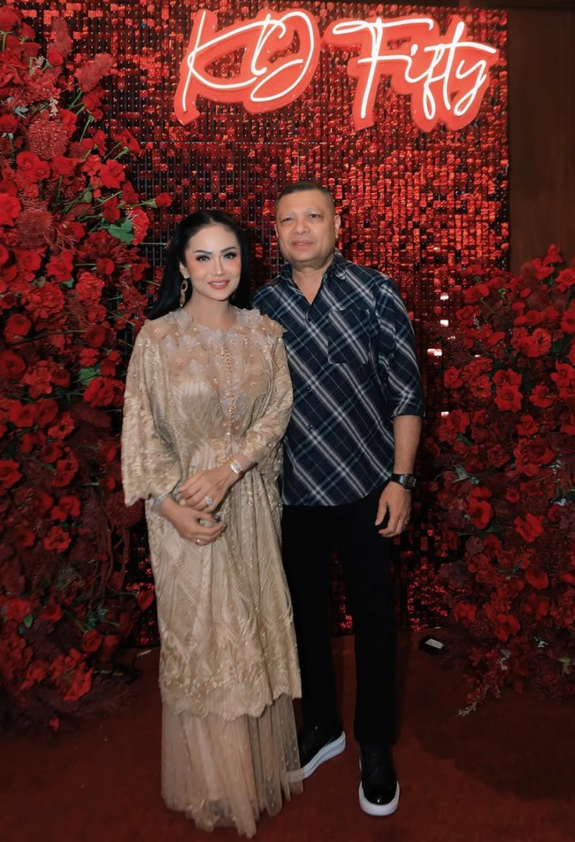 Krisdayanti sendiri tampil cantik kenakan busana berwarna coklat keemasan. Busana yang dikenakannya tampak cantik dengana payet dan aksen berbentuk bunga. Ia kemudian memadukannya dengan rok tutu warna senada. Foto: Instagram/@krisdayantilemos