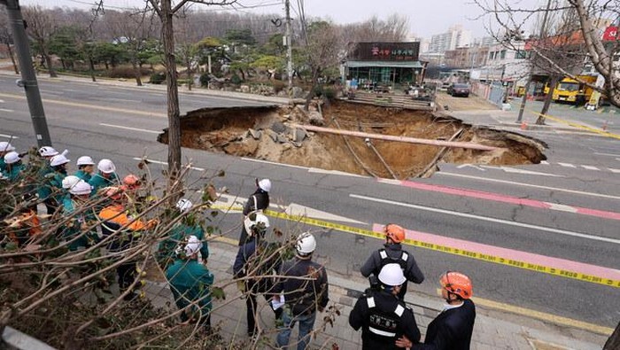 Dashcam footage showed the hole appearing abruptly in the middle of a busy street, with a motorbike being swallowed up instantly as a car narrowly escapes the same fate. (Yonhap via Reuters)