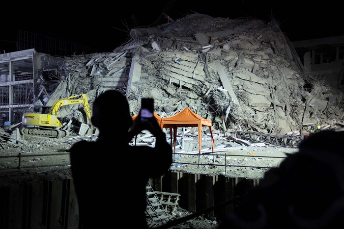 A rescue personnel searches for casualties at the site of a building that collapsed after a strong earthquake struck central Myanmar on Friday, earthquake monitoring services said, which affected Bangkok as well with people pouring out of buildings in the Thai capital in panic after the tremors, in Bangkok, Thailand, March 28, 2025. REUTERS/Athit Perawongmetha