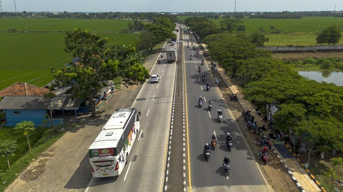 Foto udara pemudik bersepeda motor melintas di jalur Pantura Lohbener, Indramayu, Jawa Barat, Sabtu (29/3/2025). Memasuki H-2 Lebaran yang merupakan puncak arus mudik di jalur Pantura terpantau ramai dan masih didominasi kendaraan roda dua. ANTARA FOTO/Dedhez Anggara/rwa.