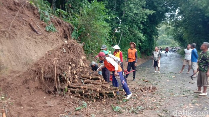 Petugas dan masyarakat saat melakukan kerjabakti pembersihan material longsoran imbas cuaca ekstrem pada Jumat (29/3/2025).