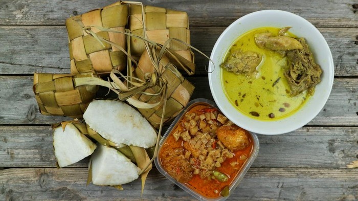 Selected Focus Ketupat Lebaran, served with Sambal Goreng Kentang, Opor Ayam and Telur Semur. Traditional Celebratory Menu during Eid al-Fitr and Eid al-Adha in Indonesia
