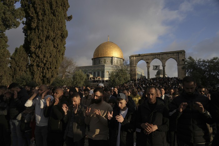 Palestinian men attend Eid al-Fitr prayers by the Dome of the Rock shrine in the Al Aqsa Mosque compound in Jerusalems Old City, Sunday, March 30, 2025. (AP Photo/Mahmoud Illean)