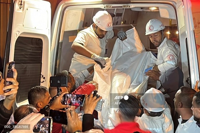 EDITORS NOTE: Graphic content / Paramedics transport out of an ambulance some of the bodies of Palestinian first responders, who were killed a week before in Israeli military fire on ambulances, into Nasser Medical Complex in Khan Yunis in the southern Gaza Strip on March 30, 2025. The Palestinian Red Crescent said on March 30 that it had recovered the bodies of 15 rescuers from the Red Crescent, Gazas civil defence agency, and one UN agency employee. The group said the those killed 