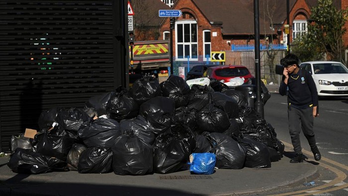 Penampakan Birmingham Inggris Dikepung Tumpukan Sampah A man walks past a pile of rubbish on the street, as the strike action by Birmingham bin workers represented by the Unite union enters its fourth week, in Sparkbrook, Birmingham, Britain, April 2, 2025. REUTERS/Jaimi Joy