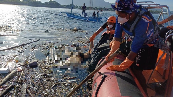 Petugas mengevakuasi mayat pria mengambang di perairan Selat Bali tepatnya di belakang Pasar Gilimanuk, Kecamatan Melaya, Kabupaten Jembrana, Sabtu (5/4/2025).