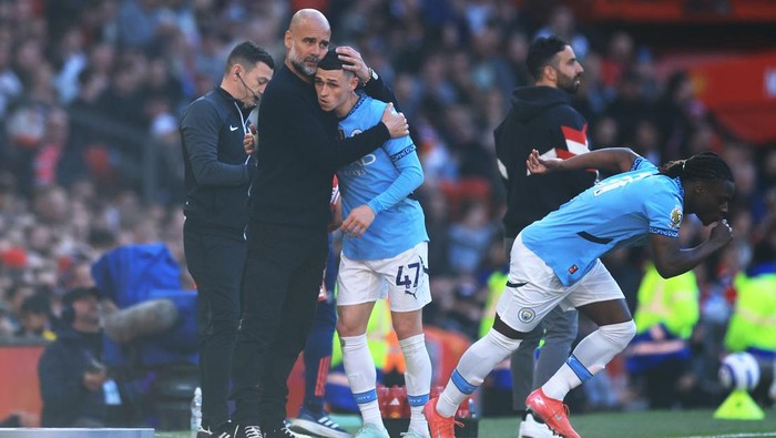 MANCHESTER, ENGLAND - APRIL 06: Pep Guardiola, Manager of Manchester City, embraces Phil Foden of Manchester City as he leaves the pitch during the Premier League match between Manchester United FC and Manchester City FC at Old Trafford on April 06, 2025 in Manchester, England. (Photo by Carl Recine/Getty Images)