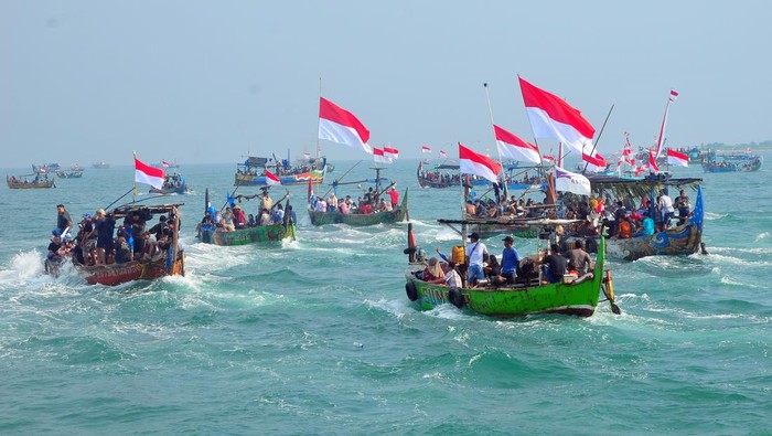 Warga naik perahu saat mengikuti prosesi Pesta Lomban di perairan Pelabuhan Kartini, Jepara, Jawa Tengah, Senin (7/4/2025). Pesta Lomban yang digelar sepekan setelah Idul Fitri dan diikuti ribuan nelayan dengan melarung sesaji berupa kepala kerbau serta hasil bumi ke tengah laut itu sebagai bentuk syukur dan harapan para nelayan kepada Tuhan atas rezeki tangkapan ikan yang melimpah serta keselamatan saat melaut. ANTARA FOTO/Yusuf Nugroho/tom.
