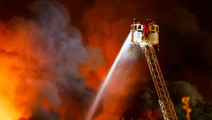 A fire truck is seen next to a building on fire, in Paris, France, April 7, 2025. REUTERS/Abdul Saboor