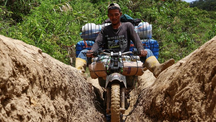 Potret Perjuangan Ojek Barang Taklukkan Medan Sulit di Luwu Utara Tukang ojek mengangkut barang melewati jalanan tanah di Kecamatan Seko, Kabupaten Luwu Utara, Sulawesi Selatan, Selasa (8/4/2025). Tarif jasa ojek dari ibu kota kabupaten menuju kecamatan dengan jarak tempuh sekitar 126 kilometer tersebut mencapai Rp700 ribu per orang dan barang rata-rata sebesar Rp5.000 per kilogram akibat akses jalan yang rusak parah.