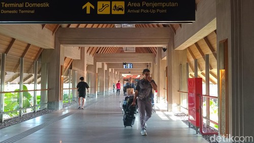 Lalu lalang penumpang dan barang bawaannya seusai mendarat di terminal domestik Bandara Internasional I Gusti Ngurah Rai, Selasa (8/4/2025).