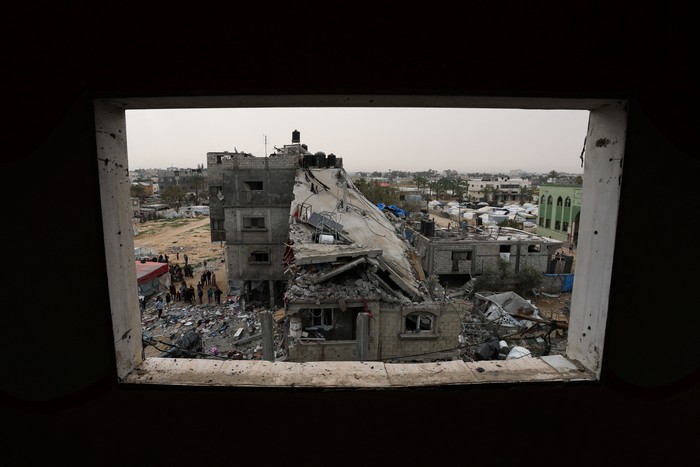 A Palestinian man sits amid rubble at the site of an Israeli strike on a house, in Deir Al-Balah in the central Gaza Strip April 7, 2025. REUTERS/Ramadan Abed     TPX IMAGES OF THE DAY