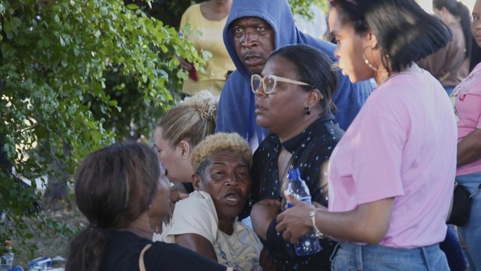 Relatives of missing people embrace while waiting at the National Institute of Forensic Pathology after the roof collapsed at Jet Set nightclub during a merengue concert in Santo Domingo, Dominican Republic, Tuesday, April 8, 2025. (AP Photo/Ricardo Hernandez)