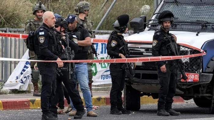 Israeli security forces gather at the scene of a reported stabbing attack near the Palestinian village of Haris and the Israeli settlement of Ariel in the northwest of the occupied West Bank on April 8, 2025. (AFP)