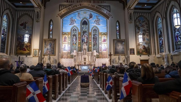 People attend a Mass for the victims of the Jet Set club roof collapse, at St. Elizabeth's Church, Wednesday, April 9, 2025 in New York. (AP Photo/Adam Gray)