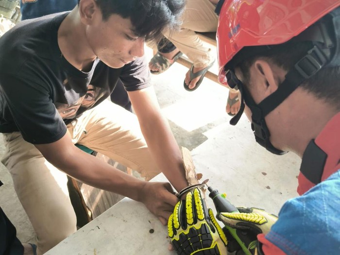 Petugas damkar melepaskan borgol dari tangan pria di Pulau Tidung Kepulauan Seribu. Foto: Dok. Istimewa.
