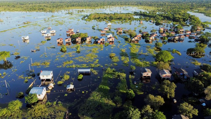 A drone view shows houses on the water in the Puerto Almacen area where many families live surrounded by water due to heavy rains causing flooding in central Bolivia, in Trinidad, Bolivia, April 6, 2025. REUTERS/Claudia Morales