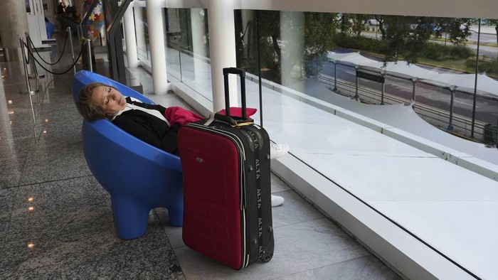 A lone worker walks inside the Retiro train station that is empty due to a general strike against the austerity measures of President Javier Milei in Buenos Aires, Argentina, Thursday, April 10, 2025. (AP Photo/Rodrigo Abd)