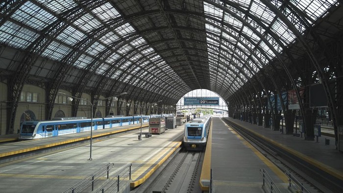 A lone worker walks inside the Retiro train station that is empty due to a general strike against the austerity measures of President Javier Milei in Buenos Aires, Argentina, Thursday, April 10, 2025. (AP Photo/Rodrigo Abd)