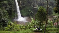 Wisatawan menikmati suasana Curug Bugbrug di Cisarua, Kabupaten Bandung Barat, Jawa Barat, Minggu (13/4/2025).