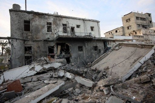 Rubble is piled up in the aftermath of an Israeli strike on the Al-Ahli hospital, also known as the Baptist or Ahli Arab hospital, in Gaza City on April 13, 2025. Gaza's civil defence agency said an Israeli airstrike destroyed parts of the hospital early on April 13, after Israel seized a corridor in the war-battered Palestinian territory and said it planned to expand its military offensive. (Photo by Omar AL-QATTAA / AFP)