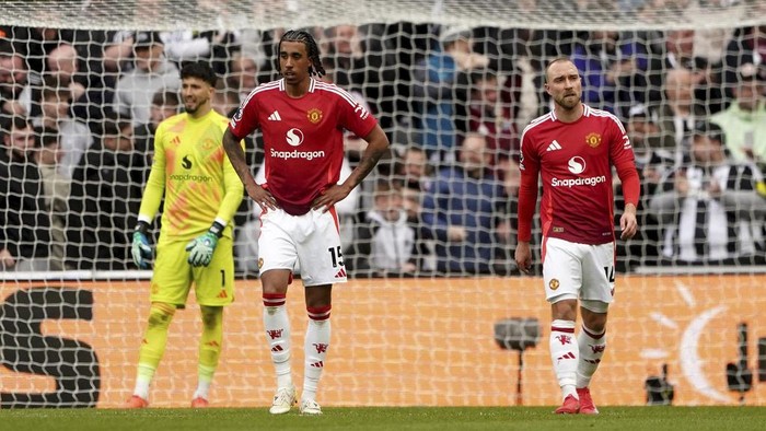 Manchester Uniteds Leny Yoro, left, and Christian Eriksen react after conceding a third goal during the English Premier League soccer match between Newcastle United and Manchester United in Newcastle upon Tyne, England, Sunday, April 13, 2025. (Owen Humphreys/PA via AP)