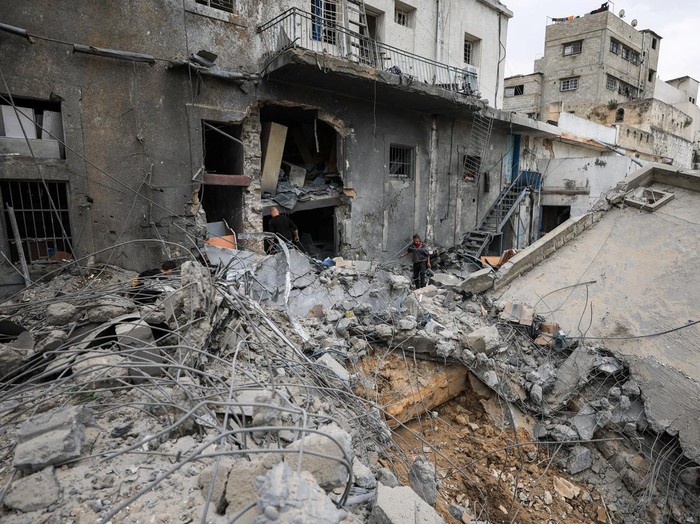 Palestinians inspect the damage after two Israeli missiles hit a building inside the Al-Ahli Arab Baptist Hospital, shortly after patients were evacuated following a call from someone who identified himself with Israeli security, in Gaza City, April 13, 2025. REUTERS/Dawoud Abu Alkas
