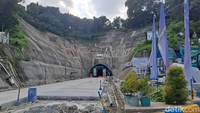 Dari jarak menengah, terlihat aktivitas pembangunan yang masih berlangsung. Dengan anggaran Rp 395,9 miliar dan progres mencapai 91,7 persen, terowongan ini ditargetkan beroperasi pada pertengahan 2025.