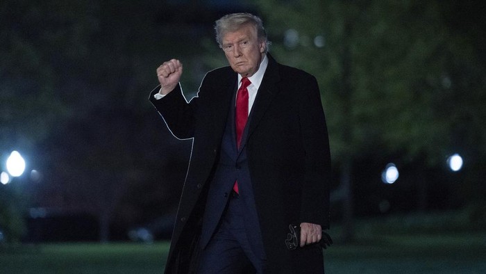 President Donald Trump gestures to reporters as he walks on the South Lawn of the White House in Washington, Sunday, April 13, 2025. (AP Photo/Jose Luis Magana)