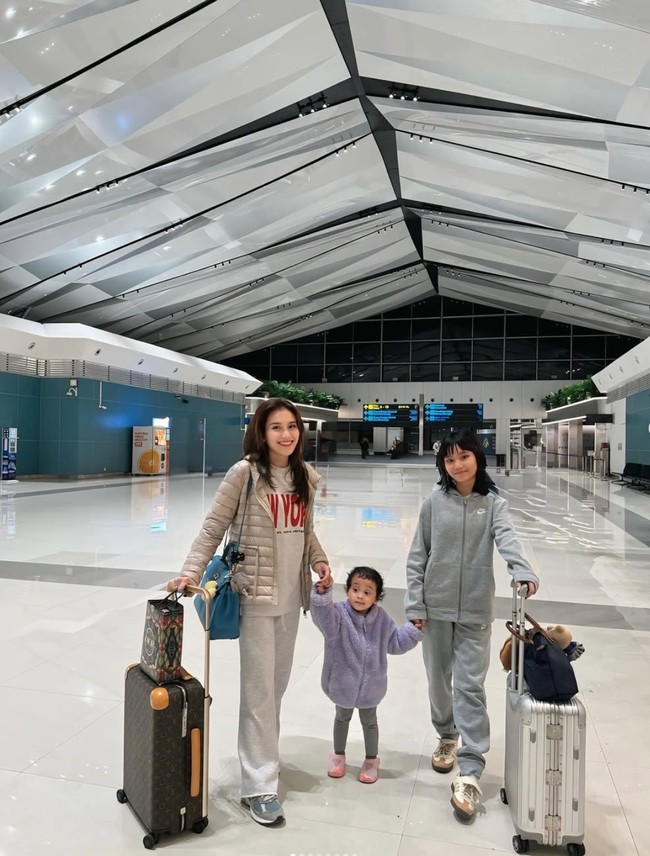 Saat akan berangkat ke Korea Ayu Ting Ting memilih tampil simpel dan sederhana dengan memadukan puffer jaket warna krem dan kaos bertuliskan New York. Untuk bawahannya ia memilih kenakan sweat pants abu-abu. Penampilannya itu kemudian dilengkapi dengan sepasang sneakers dan tas berwarna hijau turquoise. Foto: Instagram/@ayutingting92