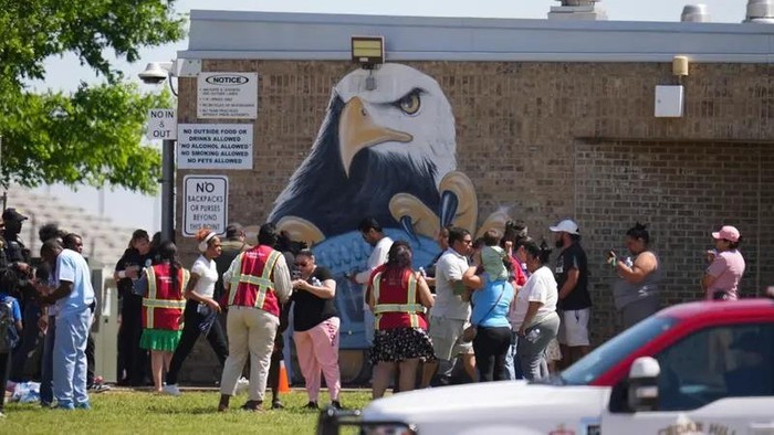 Parents are checked in to pick up their children at Wilmer-Hutchins High School, where police are responded to reports of a shooting in Dallas, Tx., Tuesday, April 15, 2025. (AP)