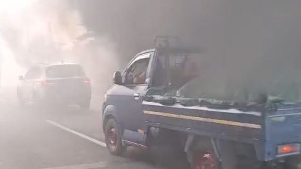 Penampakan asap kebakran menghalangi jalan tol di Jakut.