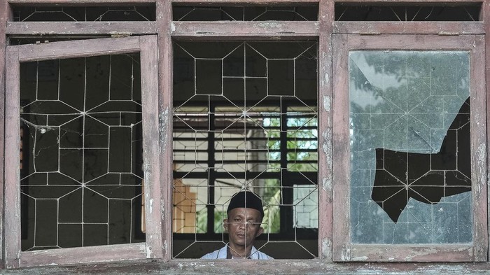 Guru berjalan di dalam ruangan bekas laboratorium yang rusak di SMPN 22 Muaro Jambi, Desa Sungai Bungur, Muaro Jambi, Jambi, Rabu (16/4/2025). Sebanyak lima ruangan termasuk laboratorium dan perpustakaan di sekolah yang memiliki 46 murid dan setiap tahunnya terdampak banjir luapan Sungai Batanghari tersebut rusak sedang hingga berat sehingga tidak bisa difungsikan sejak 2020. ANTARA FOTO/Wahdi Septiawan/wpa.