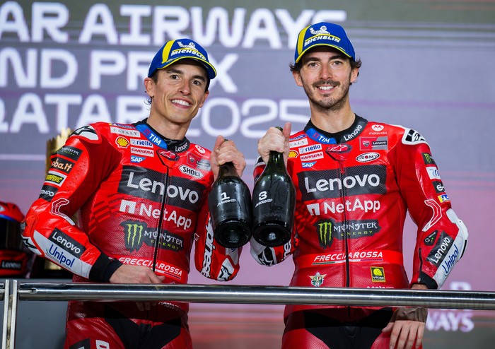 Spanish MotoGP rider Marc Marquez of the Ducati Lenovo Team, who wins, and Italian MotoGP rider Francesco Bagnaia of the Ducati Lenovo Team, who places third, celebrate on the podium with a trophy after the MotoGP final race during the Qatar Airways Motorcycle Grand Prix of Qatar at Lusail International Circuit in Lusail, Qatar, on April 13, 2025. (Photo by Noushad Thekkayil/NurPhoto via Getty Images)
