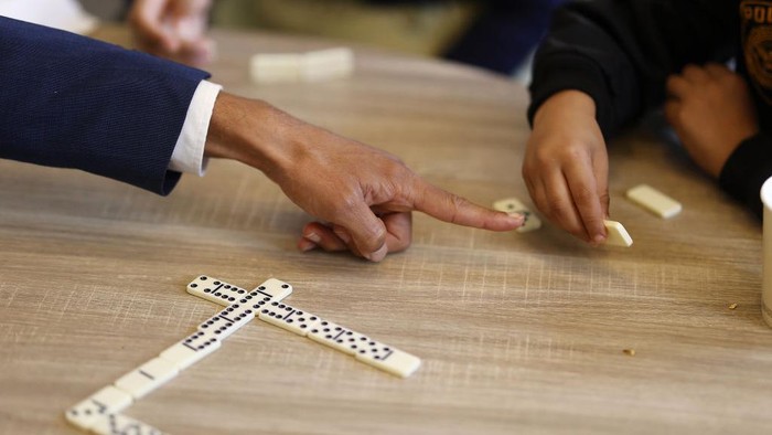 Festival at la Maison Bakhita, Paris, France. Game of dominoes. (Photo by: Godong/Universal Images Group via Getty Images)