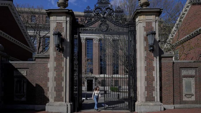 A woman walks on the campus of Harvard University in Cambridge, Massachusetts, U.S., April 15, 2025. REUTERS/Faith Ninivaggi Purchase Licensing Rights