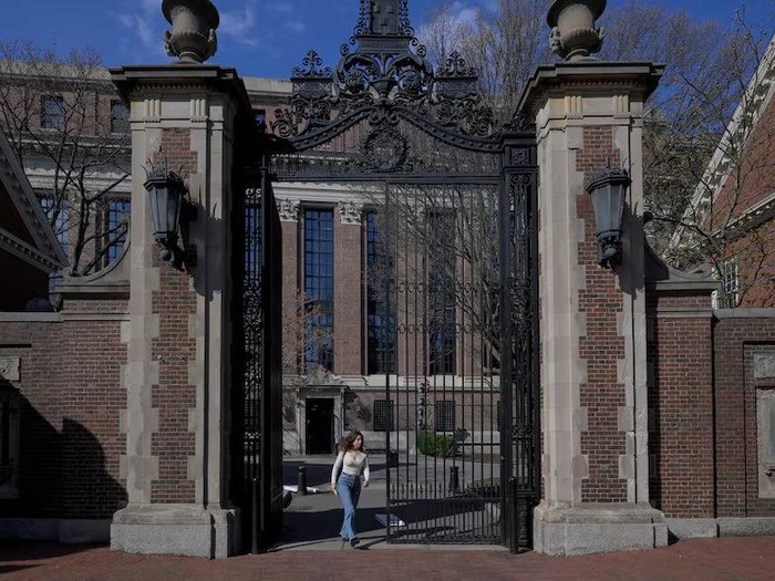 A woman walks on the campus of Harvard University in Cambridge, Massachusetts, U.S., April 15, 2025. REUTERS/Faith Ninivaggi Purchase Licensing Rights