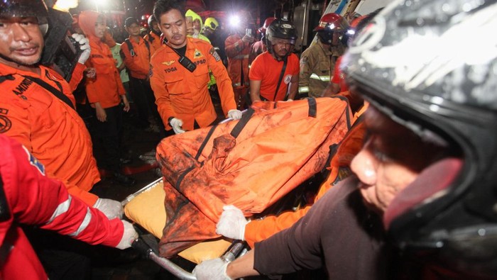Sejumlah petugas mengevakuasi jenazah korban kebakaran rumah toko di Jalan Kedung Rukem IV, Surabaya, Jawa Timur, Kamis (17/4/2025). Sebanyak 15 kendaraan pemadam kebakaran dikerahkan untuk memadamkan kebakaran ruko di kawasan pemukiman padat penduduk yang menewaskan dua orang penghuninya itu.