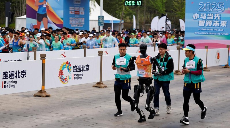 Tiangong Ultra, a humanoid robot runs across the finish line while securing the first position during the E-Town Humanoid Robot Half Marathon, in Beijing, China April 19, 2025. REUTERS/Tingshu Wang