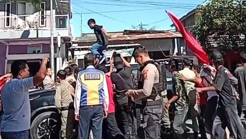 Mahasiswa menaiki mobil dinas Wakil Bupati Bima, Irfan Zubaidy, di Jalan Lintas Bima-Sumbawa, tepatnya di depan kampus STKIP Taman Siswa Padolo, Senin, (21/4/2025). (Foto: Istimewa)