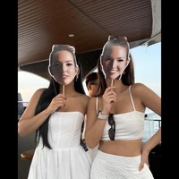 Berbeda dari Nia yang mengenakan busana bernuansa merah muda, para tamu yang datang terlihat kompak mengenakan busana serba putih. Tak hanya itu saja, merek juga mengenakan topeng bergambar wajah Nia. Foto: Instagram