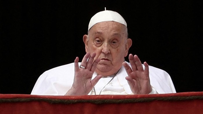 FILE PHOTO: Pope Francis gestures from a balcony, on the day the 