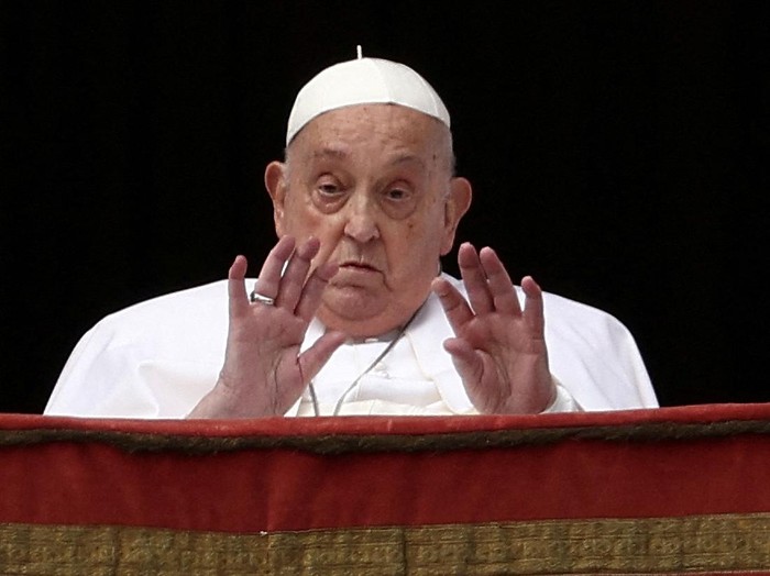 FILE PHOTO: Pope Francis gestures from a balcony, on the day the 