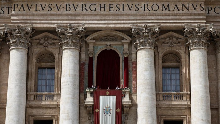Pope Francis looks on from a balcony, on the day the 