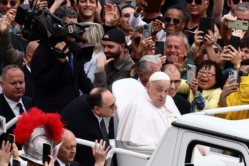 Pope Francis gestures from a balcony as the 