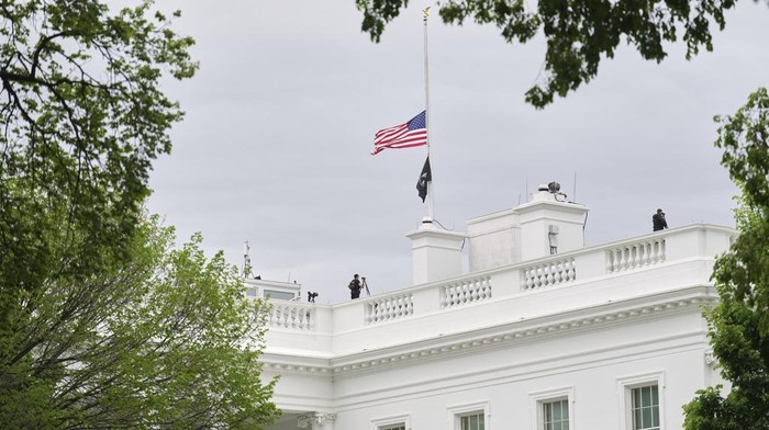 The U.S. flag is flown at half-staff at the White House in Washington in honor of Pope Francis, Monday, April 21, 2025. Pope Francis has died at age 88. (AP Photo/Jacquelyn Martin)
